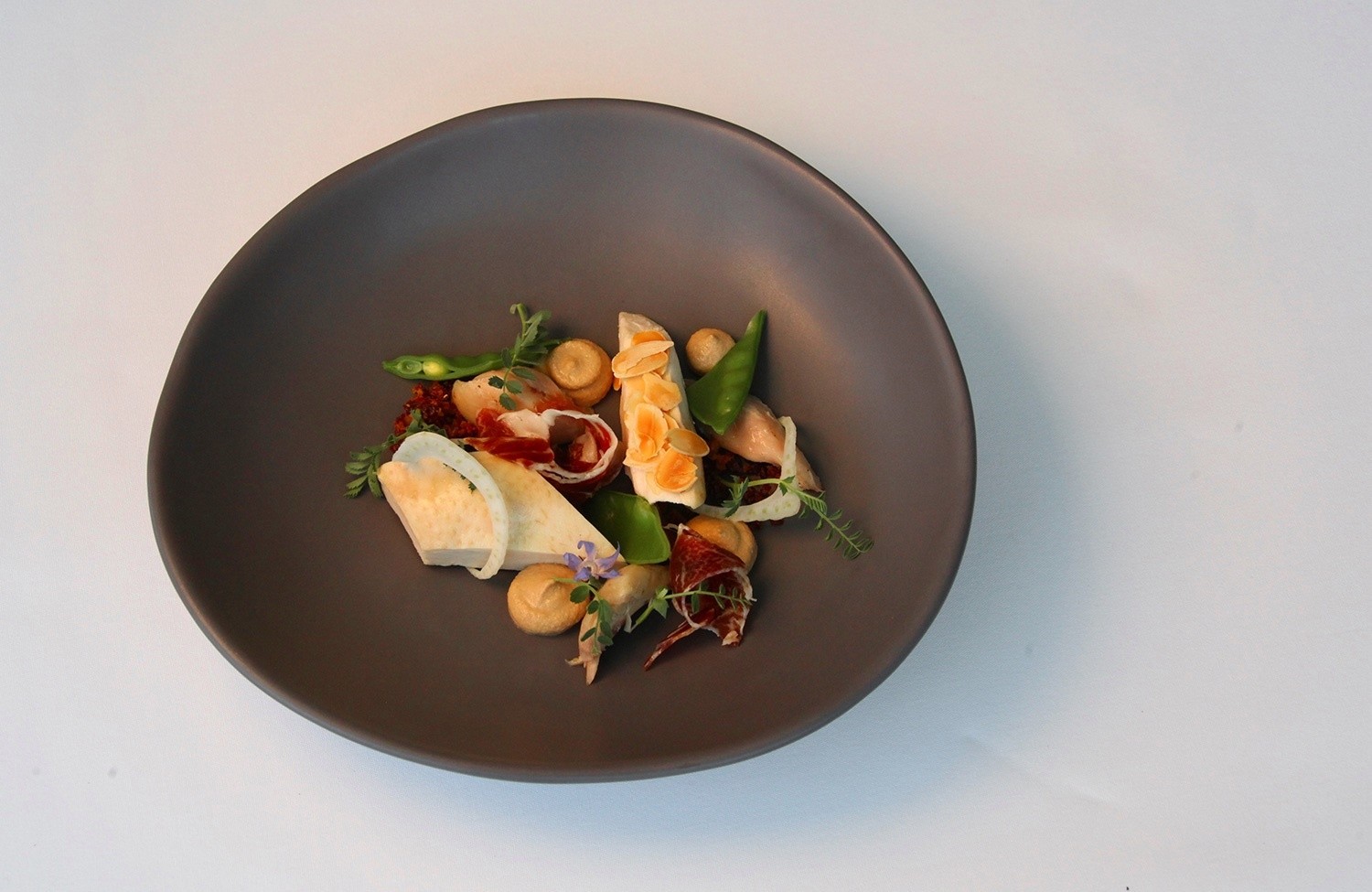 Poached Holmbrae chicken breast with jamon, snow peas and almonds at ARIA Brisbane