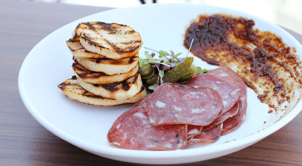 Wagyu bresaola with pickled French cornichons, peppered fig past and grilled baguette