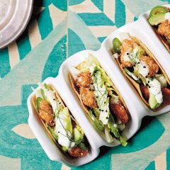 Munch on sesame crunch chicken tacos with cos, avocado and zesty crema