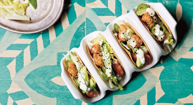 Munch on sesame crunch chicken tacos with cos, avocado and zesty crema