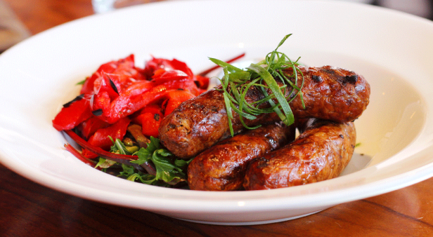 Italian sausages served with roasted capsicum